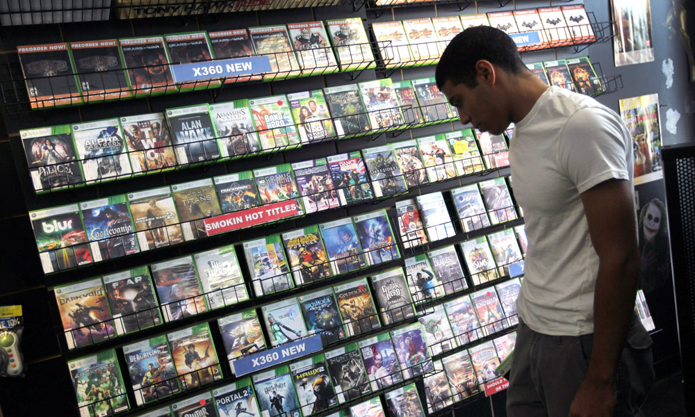 a man looking at ESRB ratings on video games