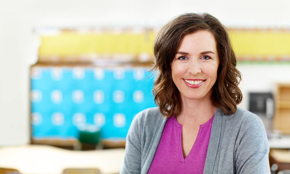 Portrait of a young schoolteacher standing in her classroom