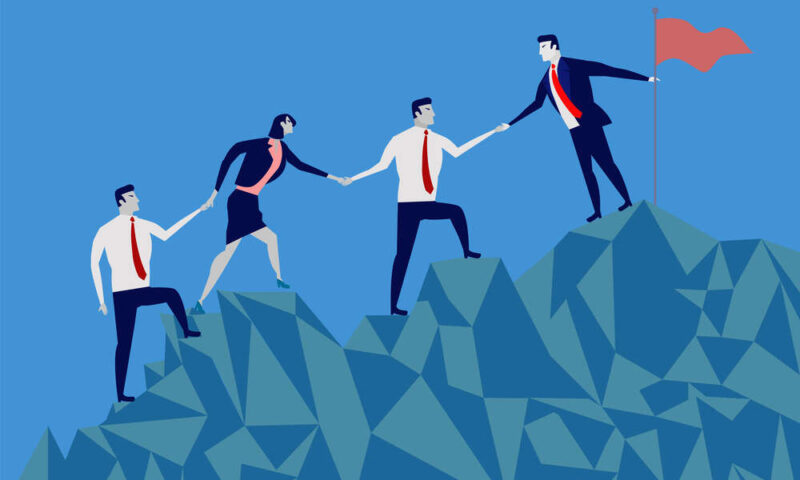 Business people climbing up a mountain
