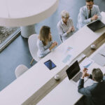 Aerial view at group of business people working together and preparing new project on a meeting in the office