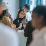 a woman checking social media during a conference coffee break