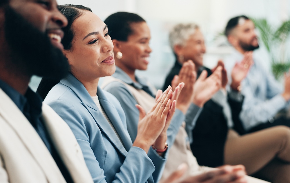 Business people, woman and team applause in conference, tradeshow and support feedback of success. Happy employees, audience and clapping in celebration, praise or winning award at seminar convention