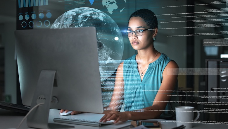 An image of a person using a computer with a holographic earth in the background, which is related to the use of AI.