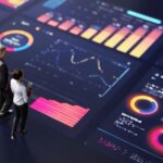 Abstract people standing on a large digital screen, analysing interactive data visualisations and charts for strategic planning. Representing teamwork, technology, and data-driven decision making in a corporate environment.