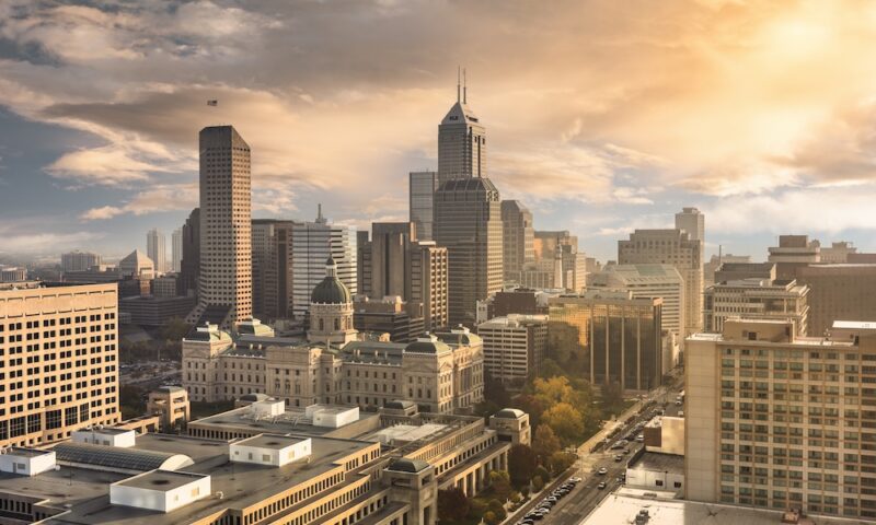 City skyline view over the downtown buildings and statehouse of Indianapolis, Indiana, USA at sunrise