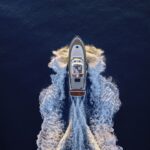Aerial view of luxury yacht moving fast at Adriatic sea during sunny day.