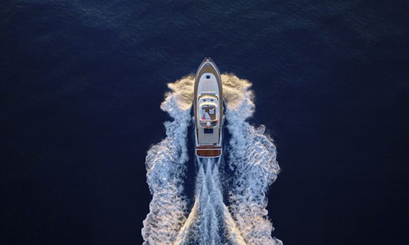 Aerial view of luxury yacht moving fast at Adriatic sea during sunny day.