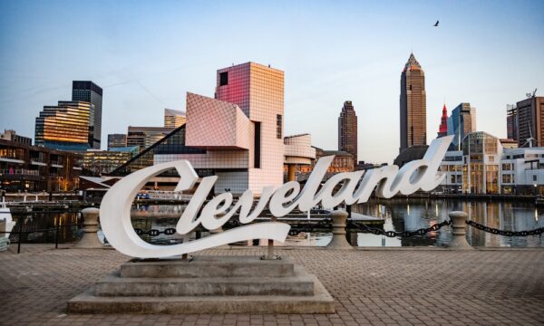 In Ohio the Cleveland script sign is placed in front of the cityscape with the Rock and Roll Hall of Fame building.