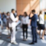 A blurred image of a group of business people attending a meeting