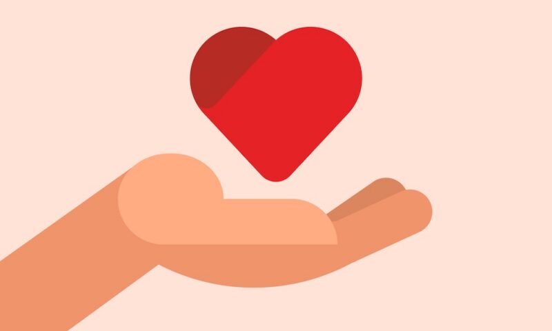 Close up of hand with a red heart concept.