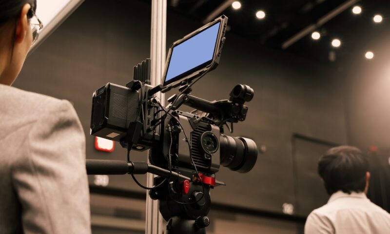 Professional cinema cameras being used in a studio or event setting.